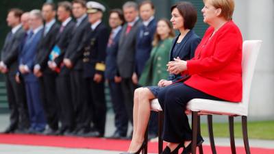 Merkel volta a sentar-se durante honras militares